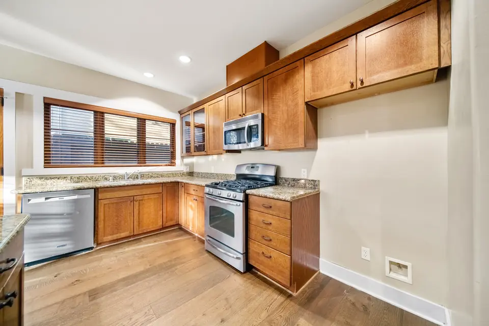 Kitchen with wood cabinets, granite counters and stainless appliances