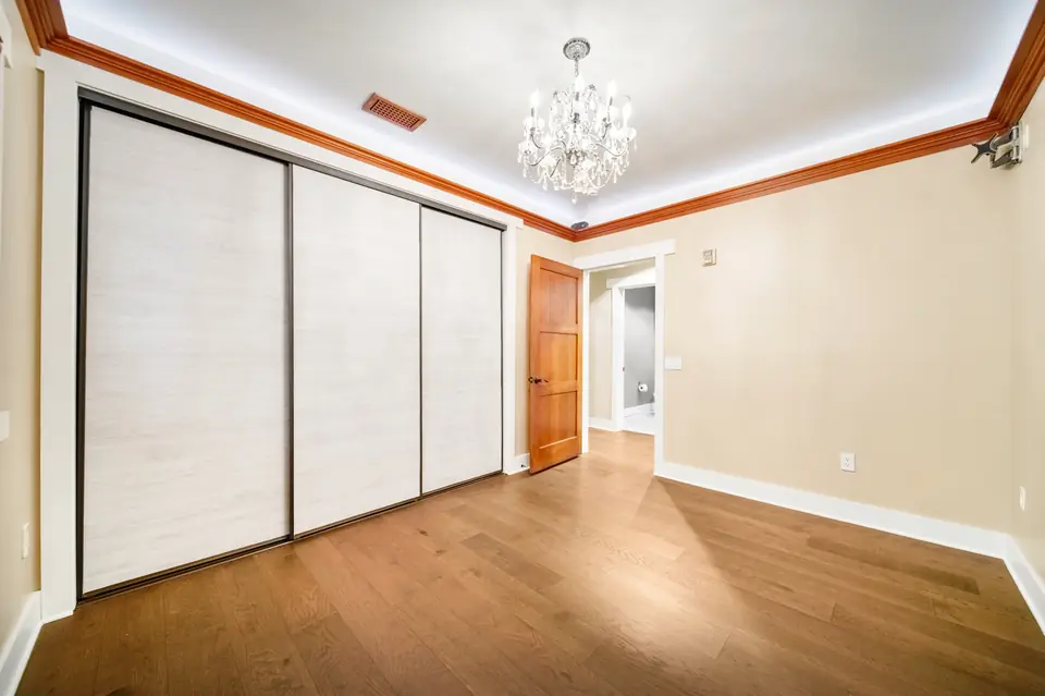 Bedroom with sliding closet doors and a chandelier