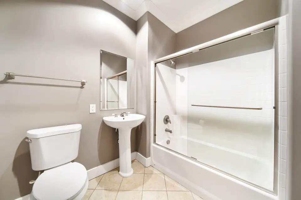 Bathroom with a pedestal sink and a tub with shower
