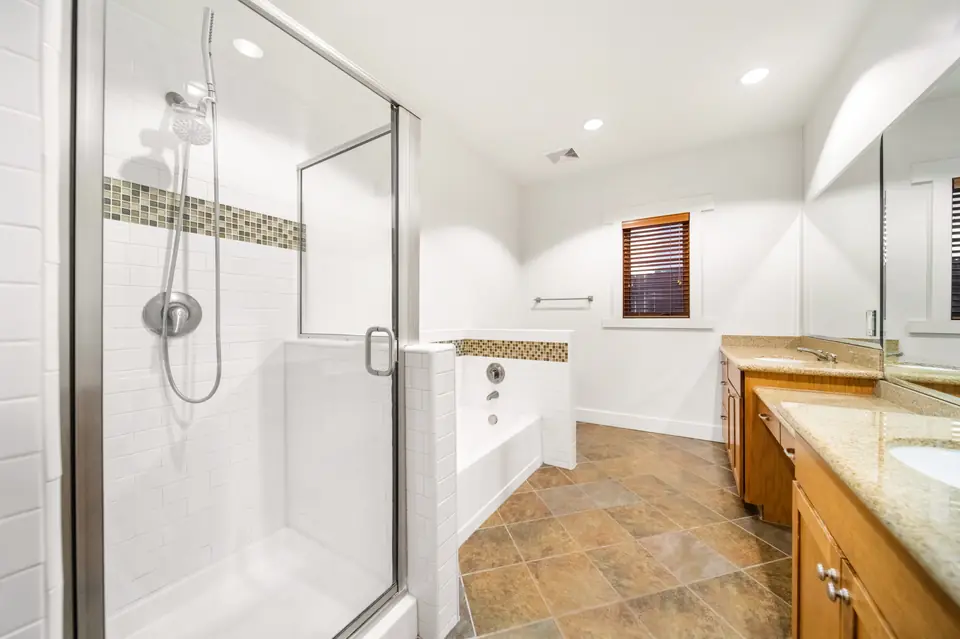 Primary bathroom with a glass shower and soaking tub