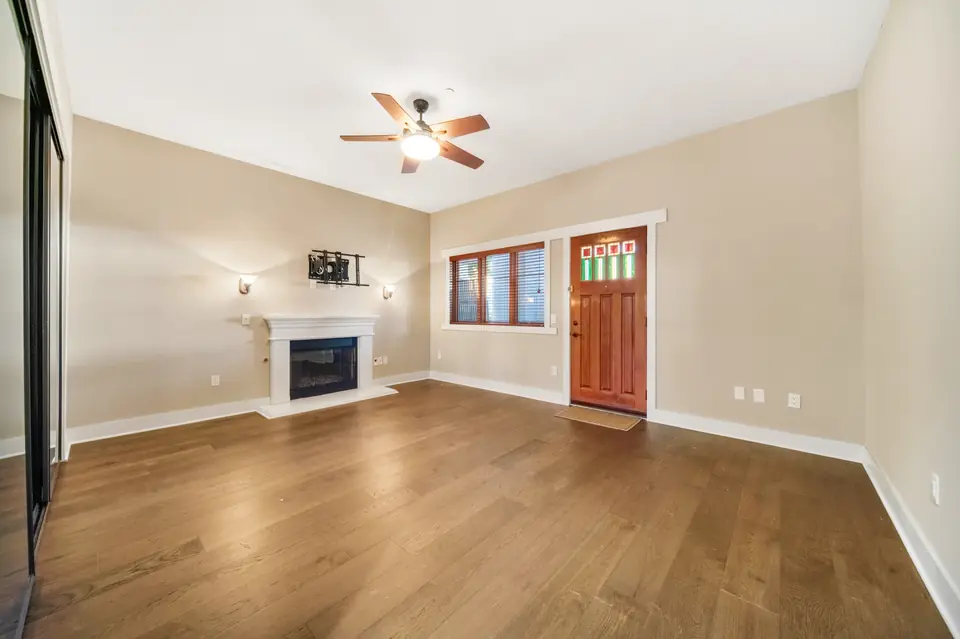 Bedroom with a fireplace and a door to the outside