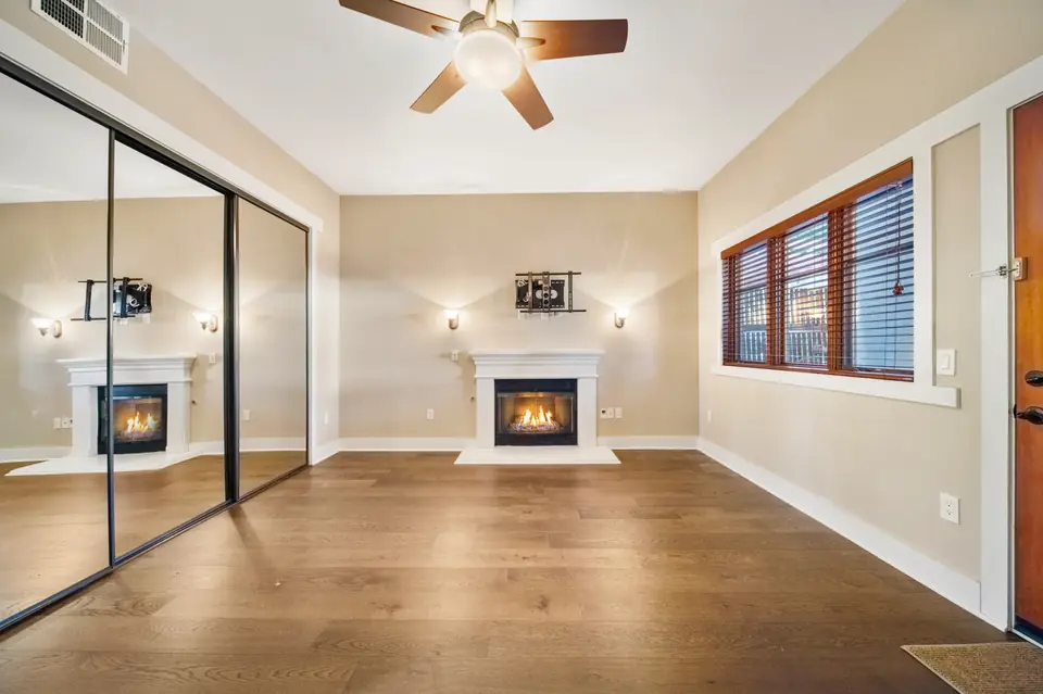 Bedroom fireplace beside mirrored closet doors. Digitally added fire