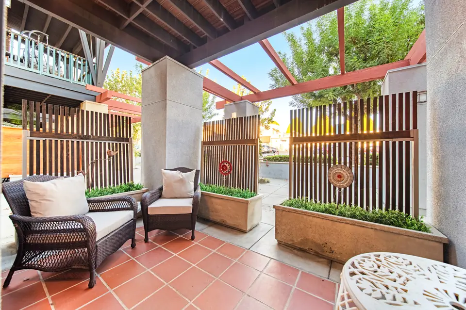 Front patio with wicker seating and wood privacy screens