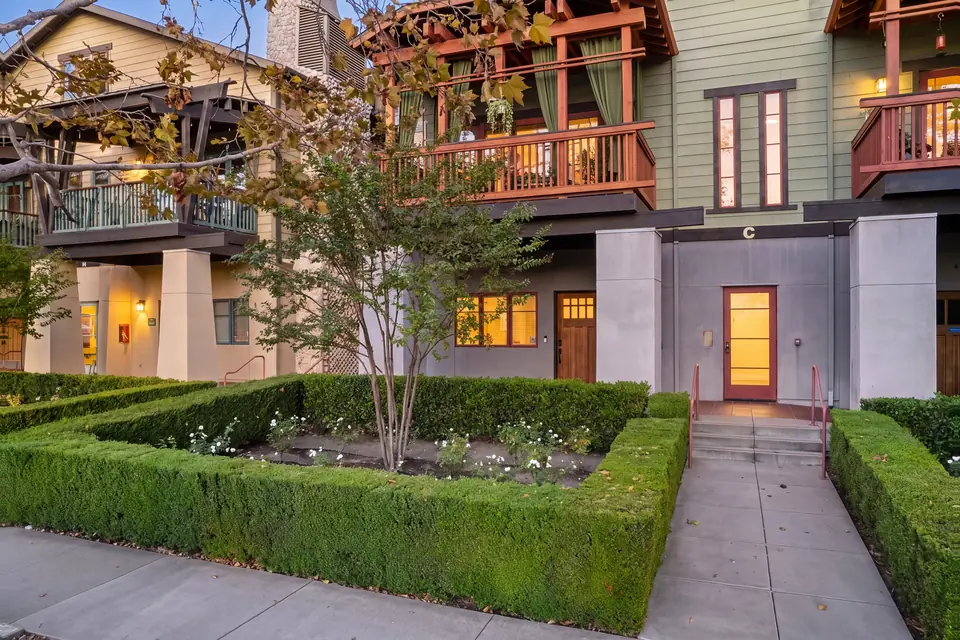 Front of the building from the garden path at twilight. Virtual twilight